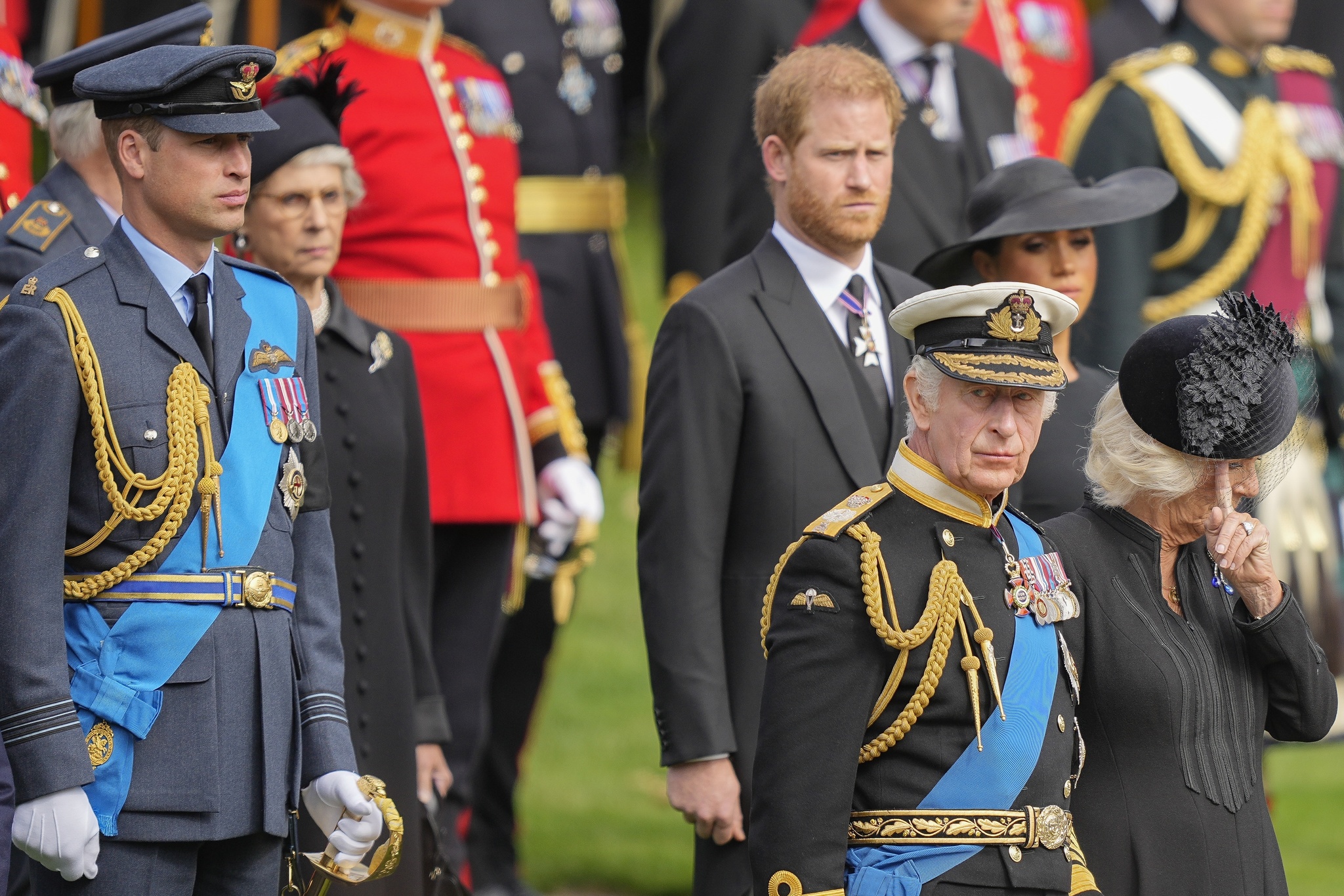 King Charles III, front right, Camilla, the Queen Consort, Prince Harry and Prince William watch as the coffin of Queen Elizabeth II is placed into the hearse